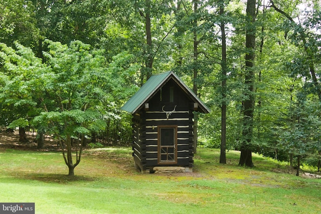 view of outdoor structure featuring a lawn