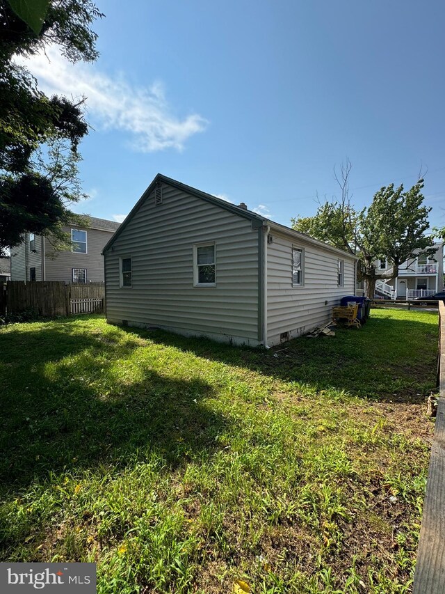 view of side of home featuring a lawn