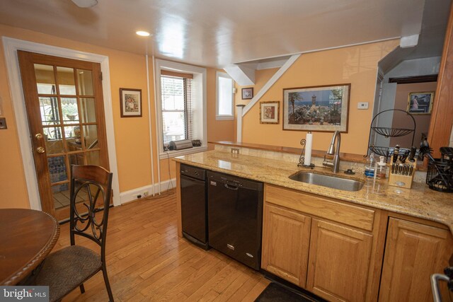 kitchen featuring light stone countertops, light hardwood / wood-style floors, dishwasher, and sink