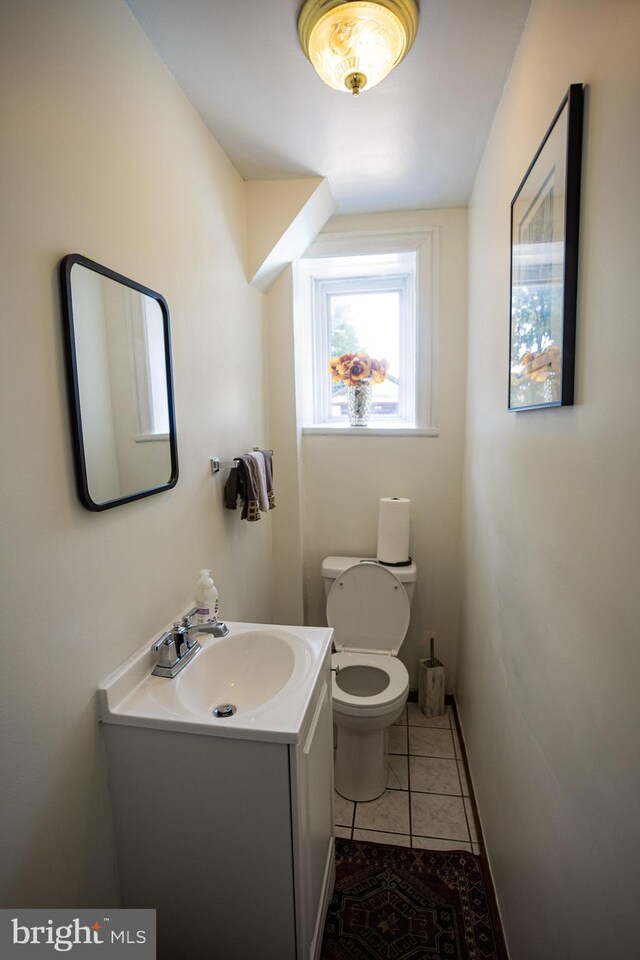 bathroom featuring toilet, vanity, and tile patterned floors