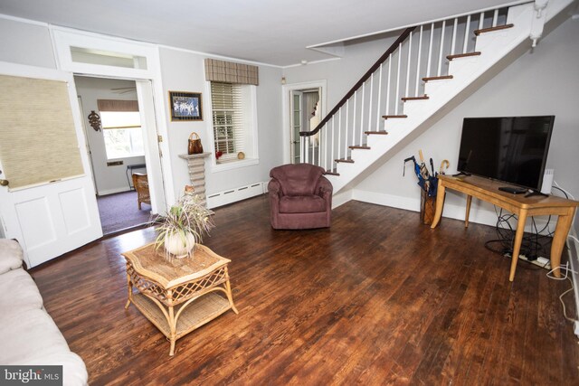 living room with baseboard heating and dark hardwood / wood-style flooring