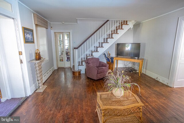 living room featuring a baseboard heating unit and dark hardwood / wood-style flooring