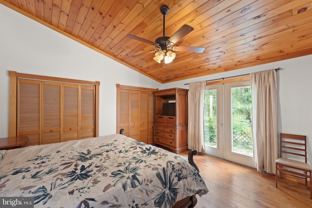 bedroom with lofted ceiling, ceiling fan, hardwood / wood-style floors, two closets, and wooden ceiling