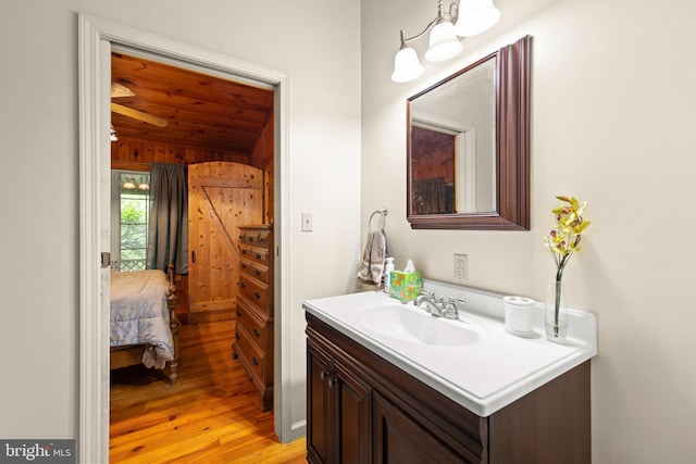 bathroom with vanity, wood ceiling, hardwood / wood-style flooring, and lofted ceiling