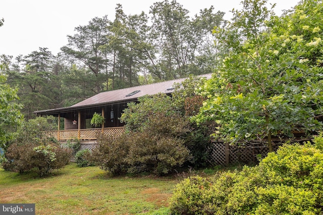 view of side of home featuring a yard