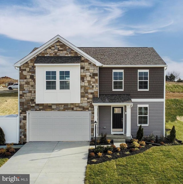 view of front of property with a garage and a front lawn