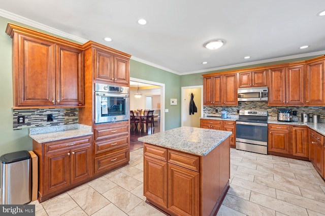 kitchen featuring a center island, backsplash, stainless steel appliances, and light stone countertops