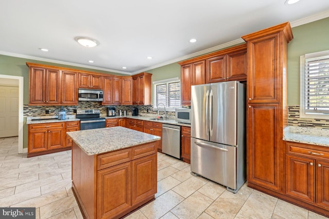 kitchen featuring a center island, a wealth of natural light, stainless steel appliances, and sink