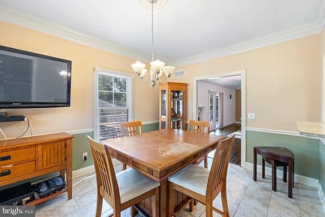 dining area with ornamental molding and a chandelier