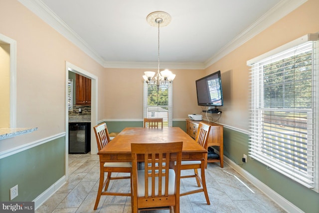 dining space with crown molding, plenty of natural light, and an inviting chandelier