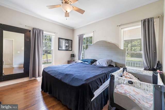 bedroom featuring crown molding, dark hardwood / wood-style flooring, and ceiling fan