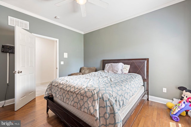 bedroom featuring ceiling fan, ornamental molding, and hardwood / wood-style floors