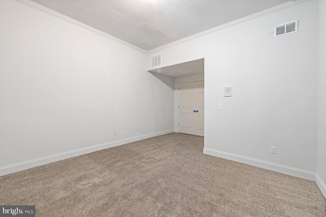 carpeted spare room with crown molding