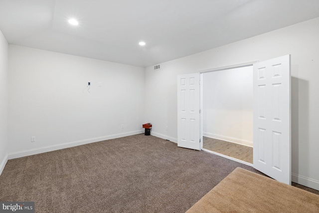 unfurnished bedroom featuring dark carpet