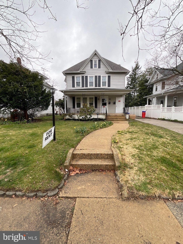 view of front of property featuring a porch and a front lawn