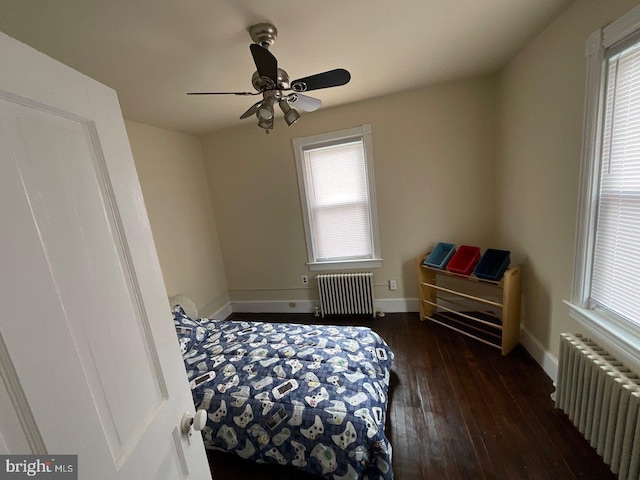 bedroom featuring ceiling fan, dark wood-type flooring, and radiator