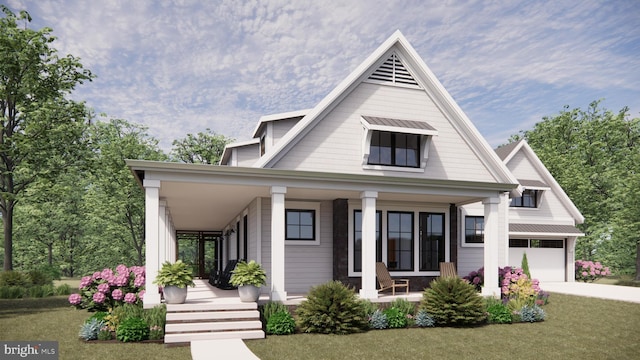 view of front of home featuring a garage, a front yard, and a porch