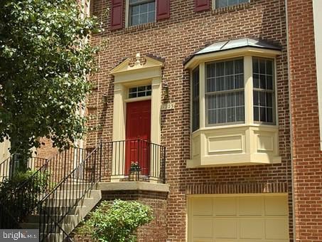 doorway to property with a garage