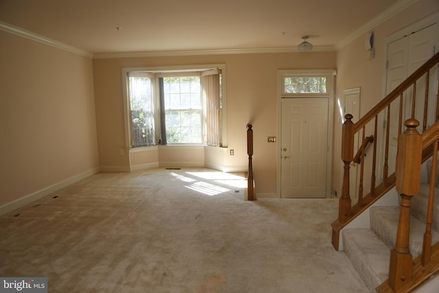 entryway featuring crown molding and light carpet