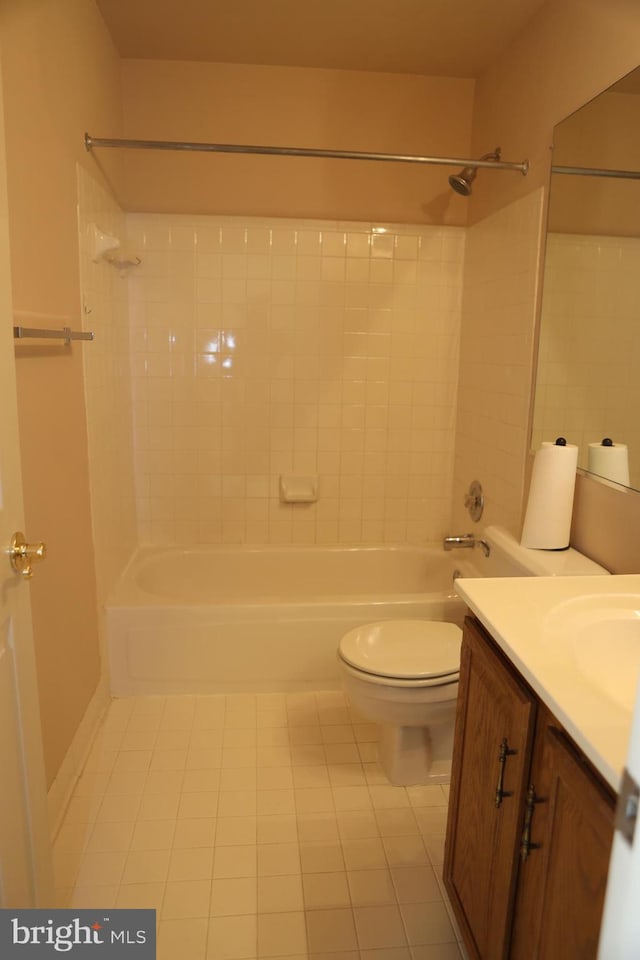 full bathroom with vanity, tiled shower / bath combo, tile patterned floors, and toilet