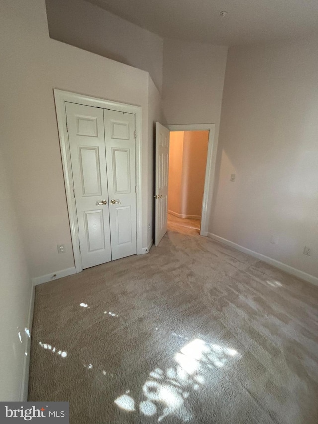 unfurnished bedroom with a closet and carpet