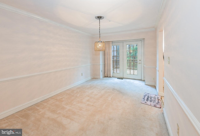 carpeted spare room featuring ornamental molding