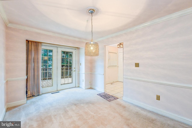 unfurnished dining area with ornamental molding and light colored carpet