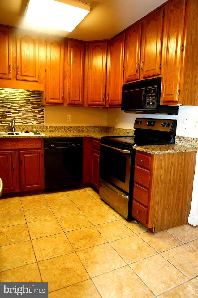 kitchen featuring sink, light tile patterned floors, and black appliances