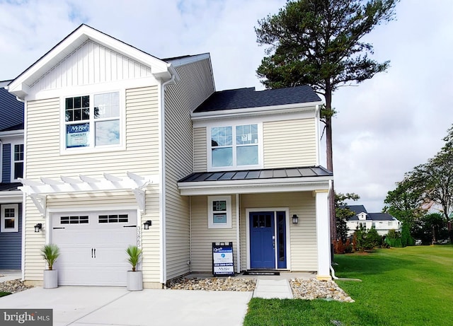 view of front of property featuring a front yard and a garage