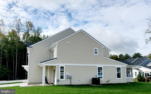 rear view of property with a lawn