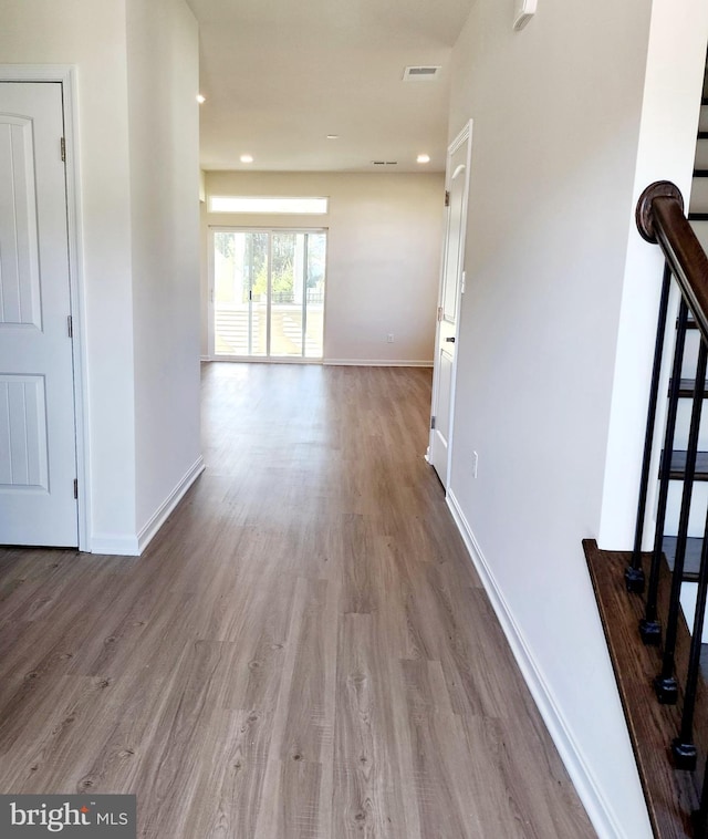 hallway with light hardwood / wood-style flooring