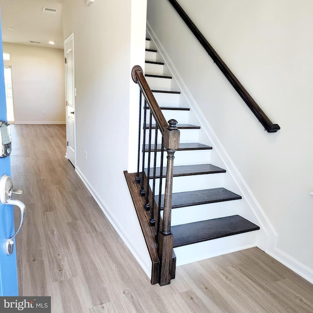 stairway featuring hardwood / wood-style flooring