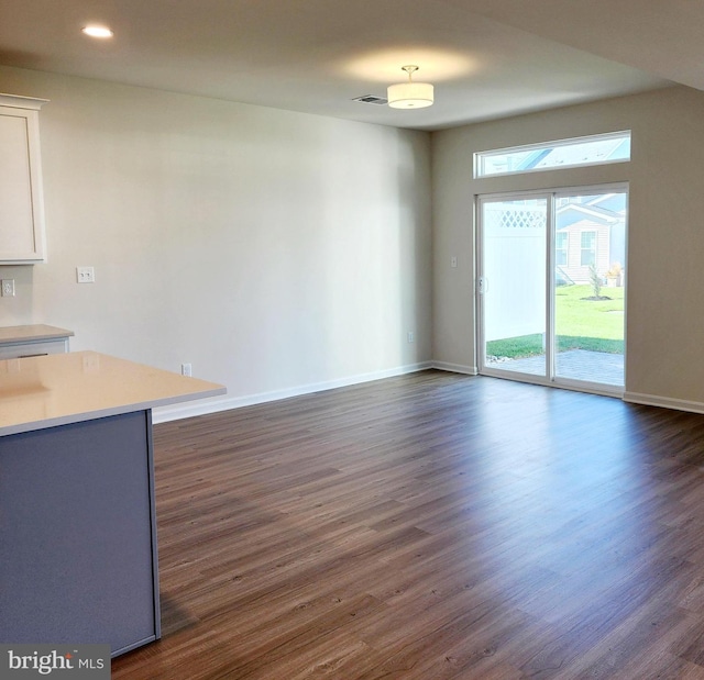 unfurnished living room with dark hardwood / wood-style floors