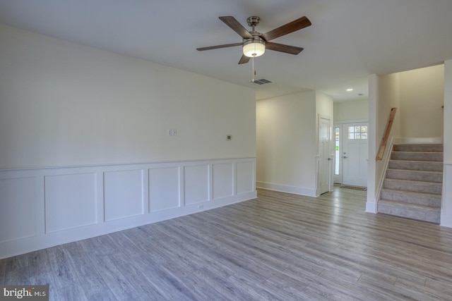 empty room with ceiling fan and light wood-type flooring