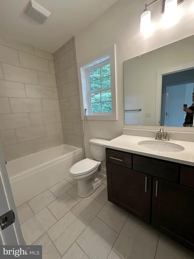 full bathroom with tile patterned flooring, vanity, toilet, and tiled shower / bath