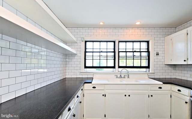 kitchen featuring sink, white cabinets, and tasteful backsplash