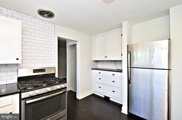 kitchen with white cabinets, backsplash, dark hardwood / wood-style flooring, and stainless steel appliances