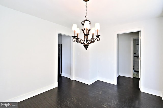 unfurnished dining area with dark hardwood / wood-style flooring and a notable chandelier