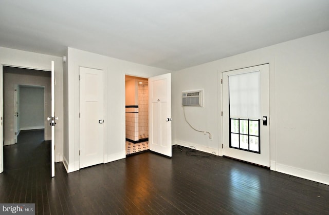 unfurnished room featuring dark hardwood / wood-style floors and a wall mounted air conditioner