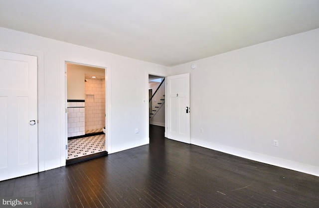 spare room with dark hardwood / wood-style floors