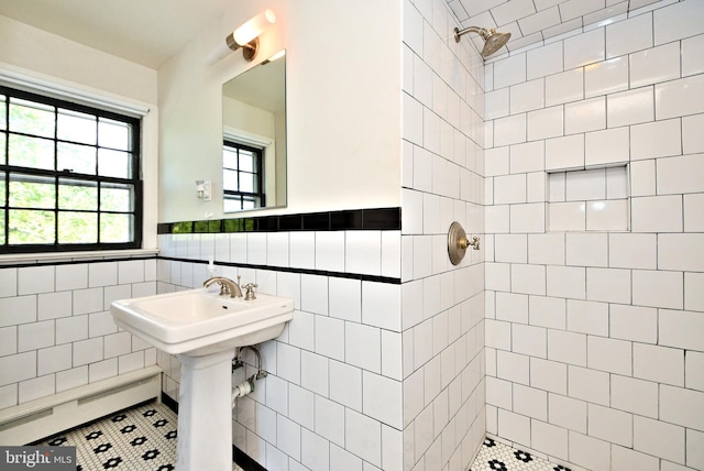 bathroom featuring sink, tile walls, a tile shower, and tile patterned flooring