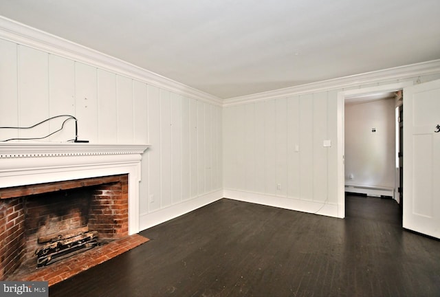 unfurnished living room with a brick fireplace, a baseboard heating unit, dark hardwood / wood-style floors, and ornamental molding