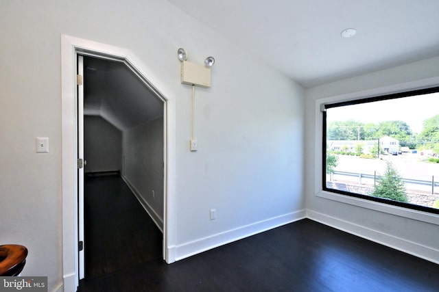 empty room featuring dark hardwood / wood-style flooring