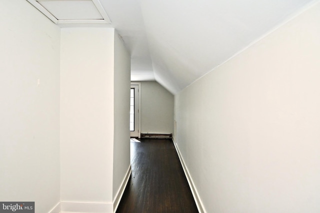 hallway with dark hardwood / wood-style flooring and vaulted ceiling