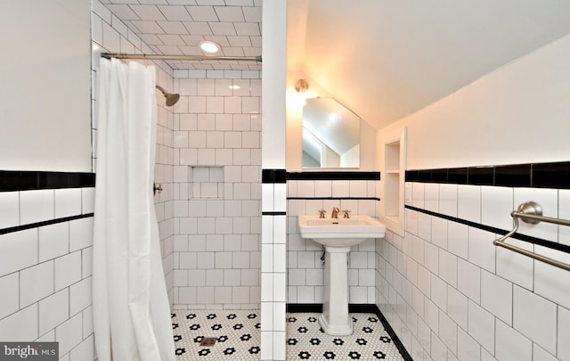 bathroom with tile walls, walk in shower, and tile patterned flooring