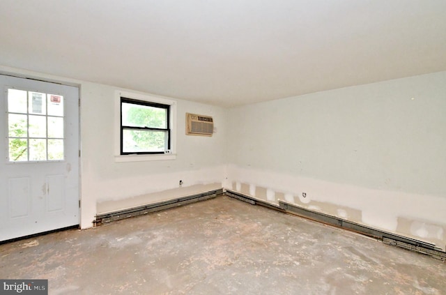 empty room featuring baseboard heating, concrete flooring, and a wall mounted AC