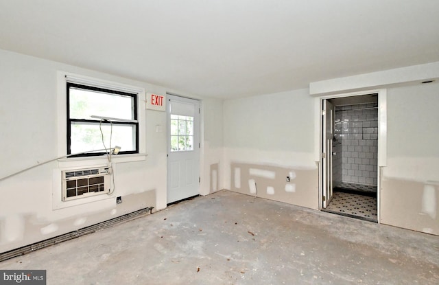 empty room with heating unit and a wall unit AC