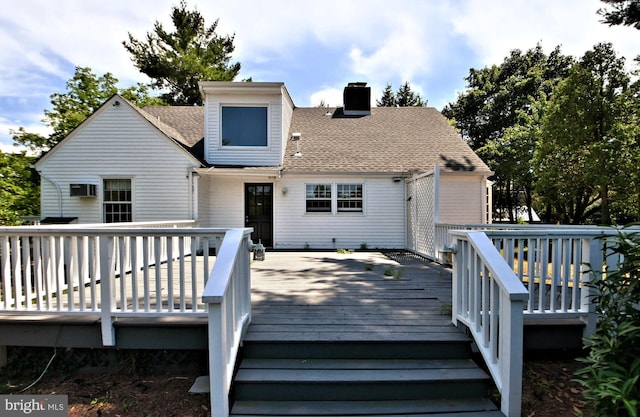 back of house featuring a deck and an AC wall unit