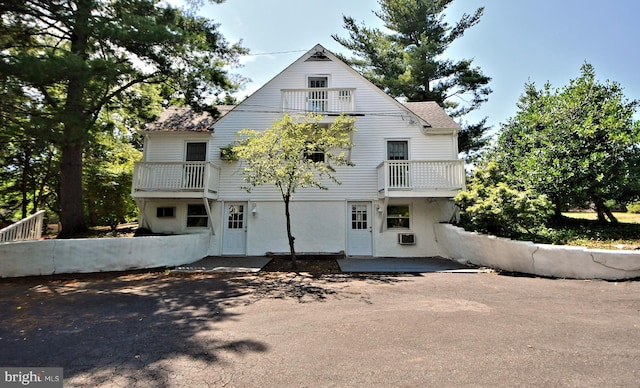 view of front of house featuring a patio area and a balcony