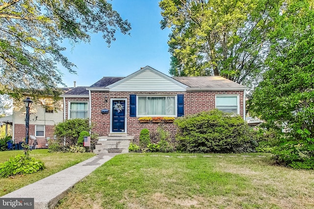 bungalow-style home with a front yard